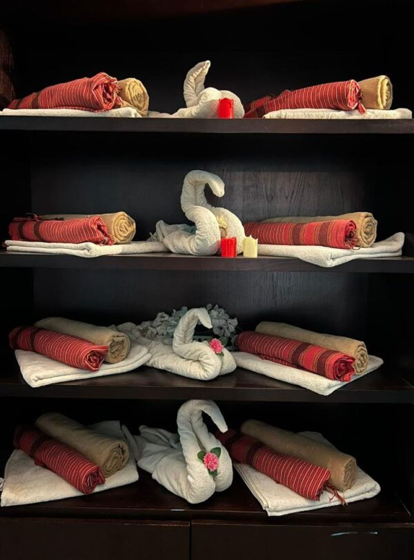 Neatly folded towels and swan decorations on a shelf in a luxury spa and Turkish bath in Hurghada