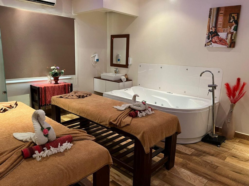Relaxing couples massage room with two beds and a private jacuzzi at a top-rated spa center in Hurghada